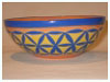 A Bali stoneware small bowl, decorated with blue geomatric design on yellow background  - third view..